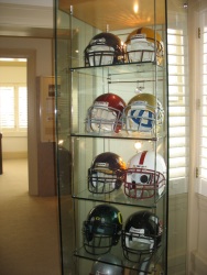 Glass case of Pac-10 helmets
