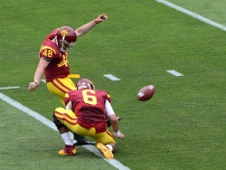 Cody Kessler holds the football for a P.A.T. by Andre Heidari